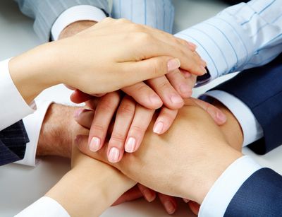 Six Hands reaching over each other. Photo: Colourbox